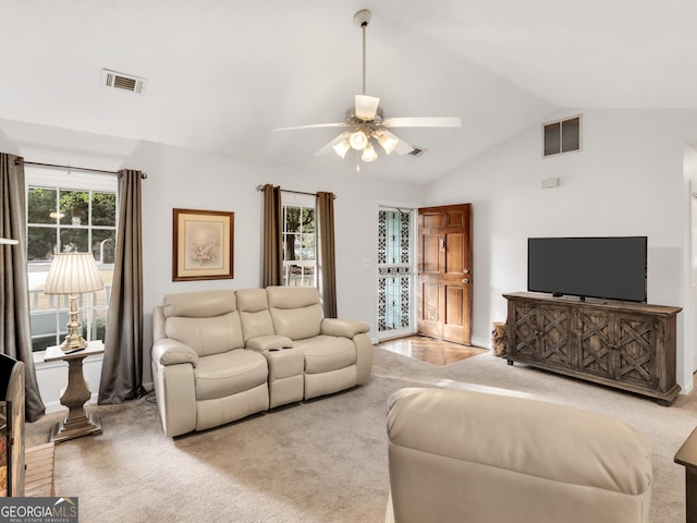 carpeted living room featuring a ceiling fan, visible vents, and vaulted ceiling