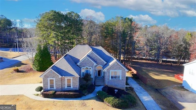 view of front of house featuring stone siding and concrete driveway