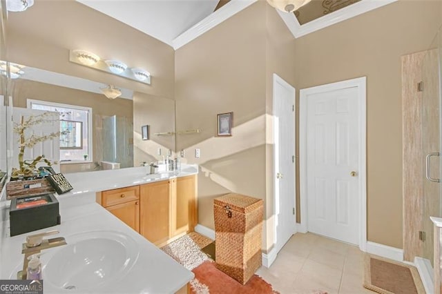 bathroom with a stall shower, baseboards, tile patterned floors, crown molding, and vanity