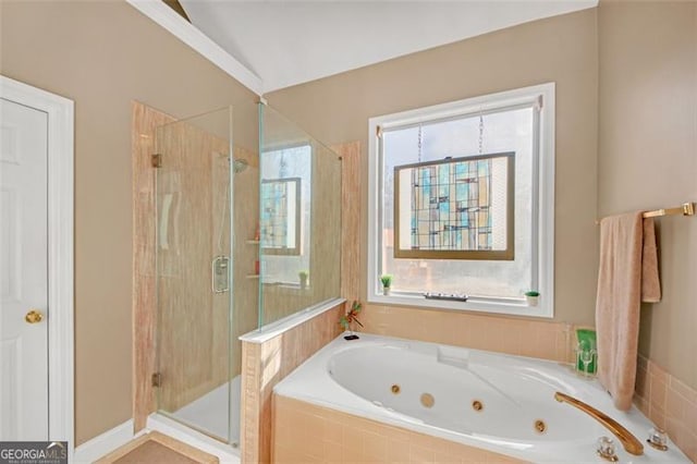 bathroom featuring a jetted tub and a shower stall