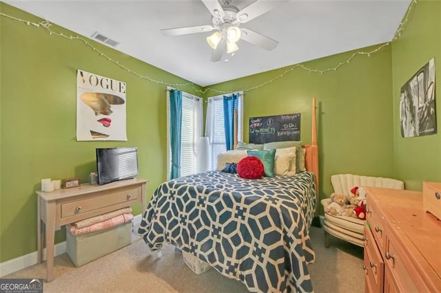 carpeted bedroom with a ceiling fan, visible vents, and baseboards