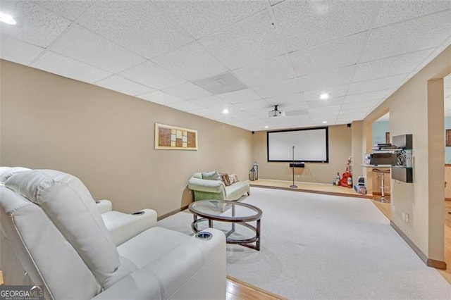 home theater with recessed lighting, a paneled ceiling, and baseboards