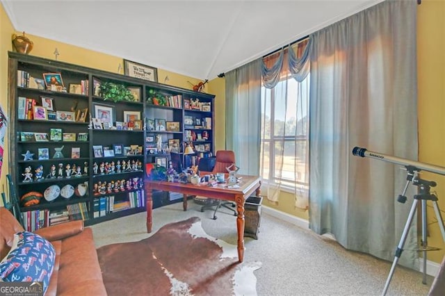 carpeted home office featuring vaulted ceiling and baseboards