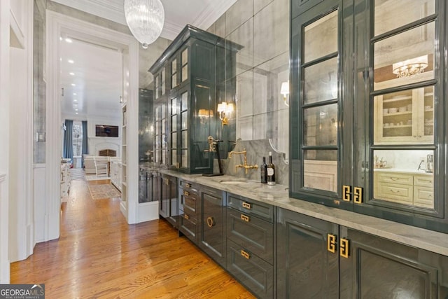 bar with wood finished floors and crown molding