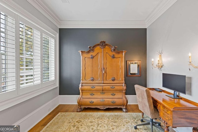 office space featuring crown molding, baseboards, and wood finished floors