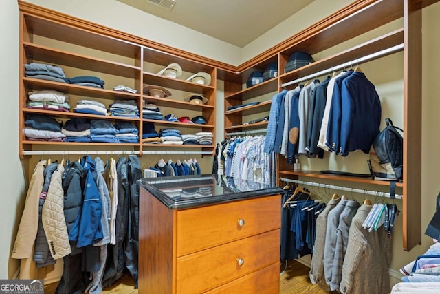 walk in closet with light wood-style flooring and visible vents