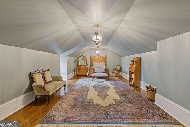 living area with lofted ceiling, a notable chandelier, baseboards, and wood finished floors