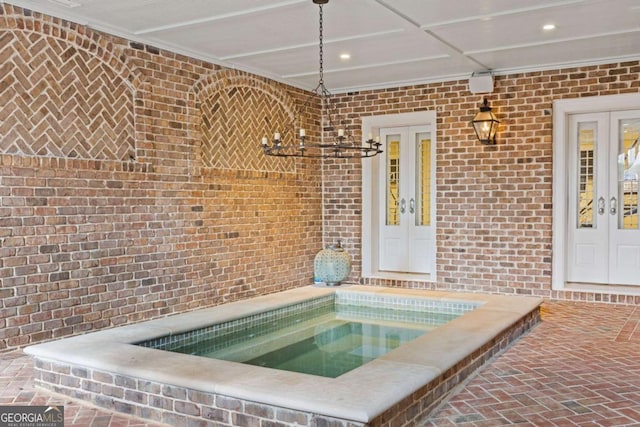 interior space featuring an indoor in ground hot tub and french doors