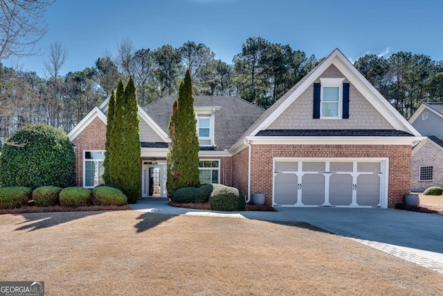 2477 Misty Rose Ln, Loganville, GA 30052 - view of front of house with brick siding, concrete driveway, an attached garage, and a shingled roof