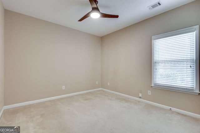 unfurnished room featuring carpet, visible vents, ceiling fan, and baseboards