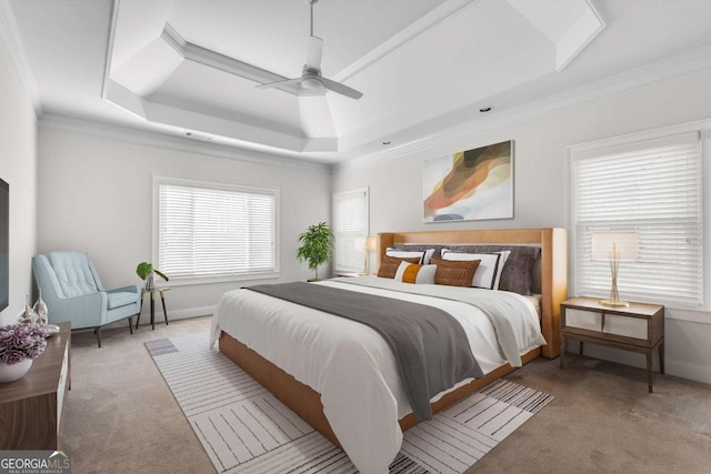 bedroom with a ceiling fan, baseboards, carpet, a raised ceiling, and crown molding