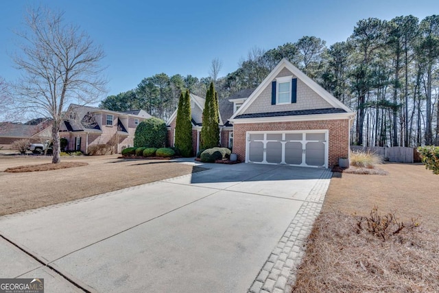 view of front facade featuring driveway, a garage, and brick siding