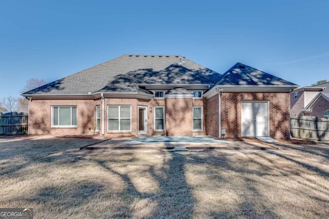 2477 Misty Rose Ln, Loganville, GA 30052 - view of front facade featuring brick siding, a front yard, and fence