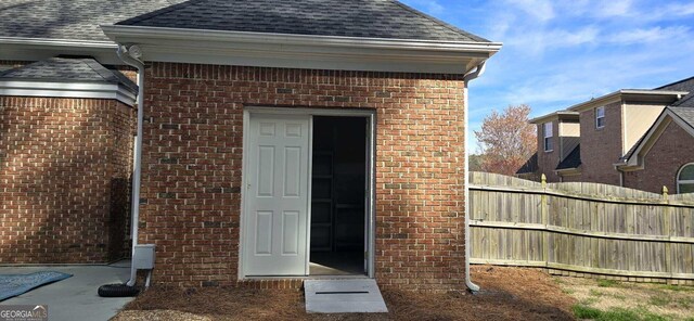 2477 Misty Rose Ln, Loganville, GA 30052 - property entrance featuring fence, brick siding, and a shingled roof