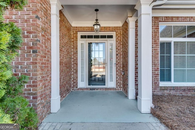 doorway to property with brick siding