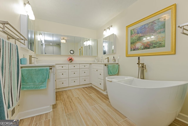 full bath featuring double vanity, a freestanding tub, and wood tiled floor