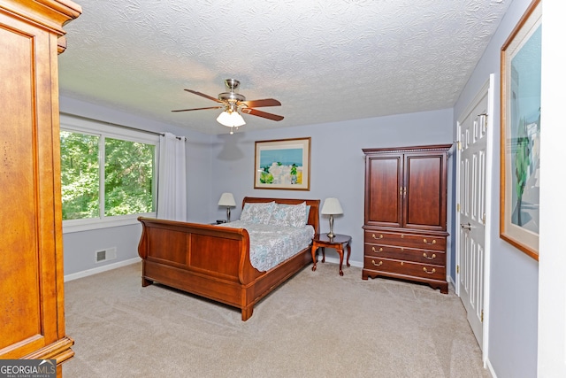 bedroom featuring light colored carpet, a closet, visible vents, and baseboards