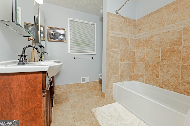 bathroom featuring visible vents, toilet, tile patterned flooring, a textured ceiling, and vanity