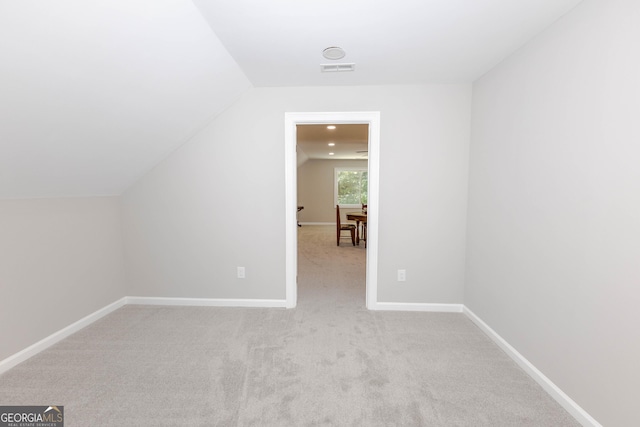 additional living space featuring lofted ceiling, carpet, and baseboards