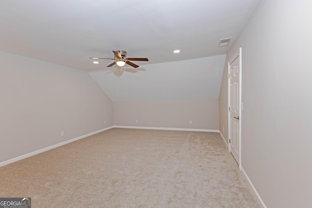 additional living space featuring vaulted ceiling, carpet flooring, visible vents, and baseboards