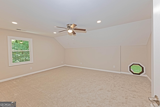 bonus room with lofted ceiling, carpet flooring, and baseboards