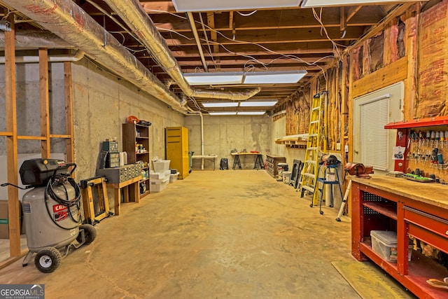 misc room with concrete flooring and a workshop area