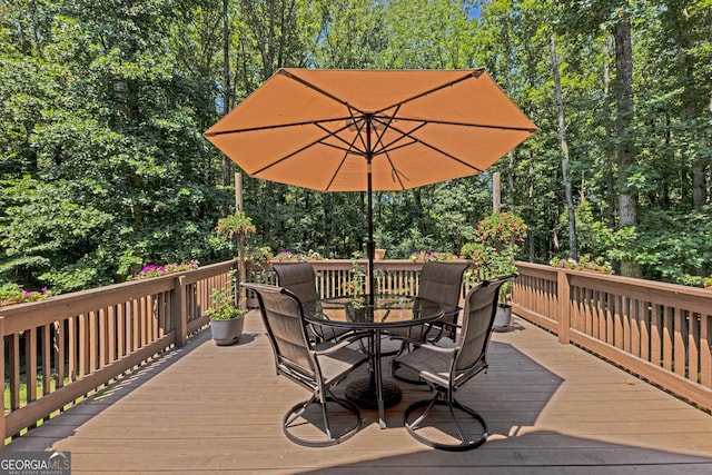 wooden terrace with outdoor dining space