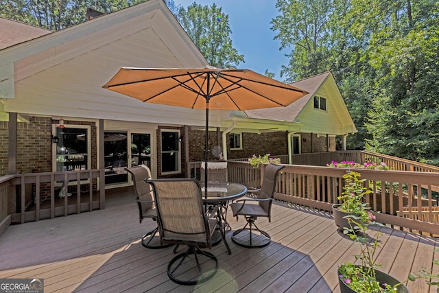 wooden terrace with outdoor dining space