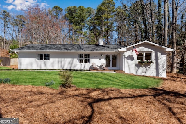 back of house with french doors, brick siding, a lawn, and crawl space