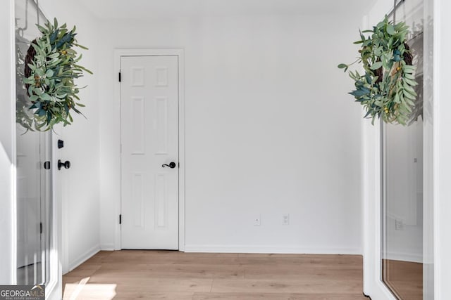 interior space featuring light wood finished floors and baseboards