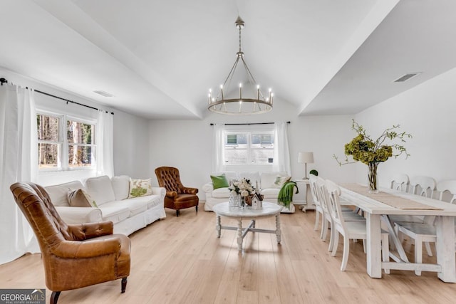 living room with light wood-style floors, a healthy amount of sunlight, and visible vents