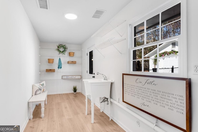 interior space with wood finished floors and visible vents