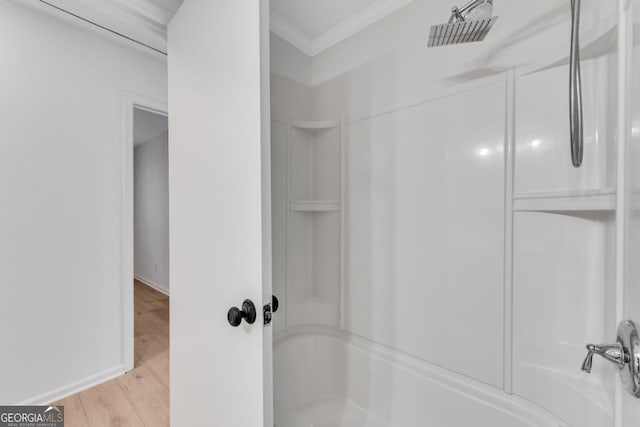 full bath with ornamental molding, shower / bath combination, baseboards, and wood finished floors