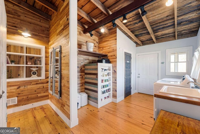 bathroom featuring beam ceiling, wood walls, wooden ceiling, and visible vents