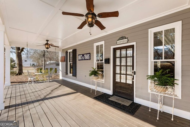 wooden deck with a ceiling fan and covered porch