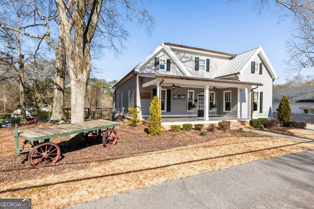 view of front facade featuring a porch, metal roof, and a ceiling fan