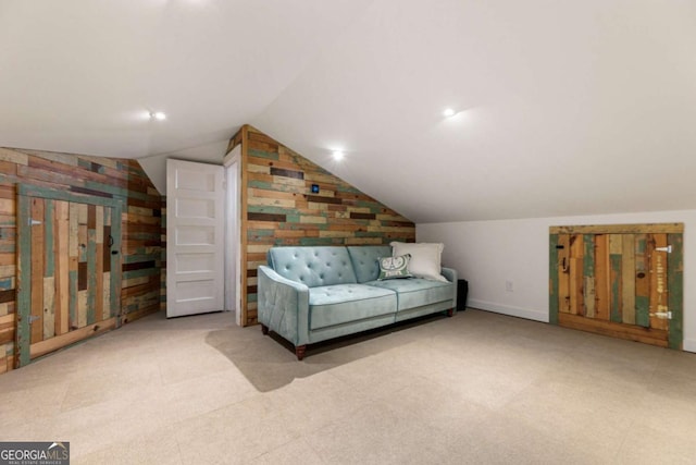 sitting room with lofted ceiling, carpet, and baseboards