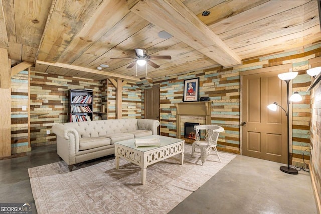 living room featuring a warm lit fireplace, concrete flooring, wood walls, a ceiling fan, and wood ceiling