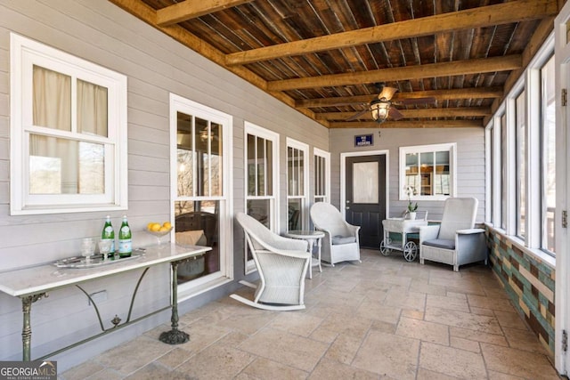 sunroom / solarium with wooden ceiling, ceiling fan, and beamed ceiling