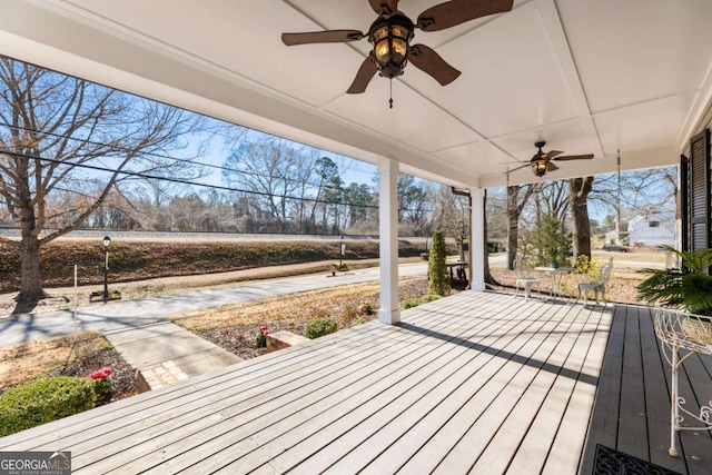 wooden terrace with a ceiling fan