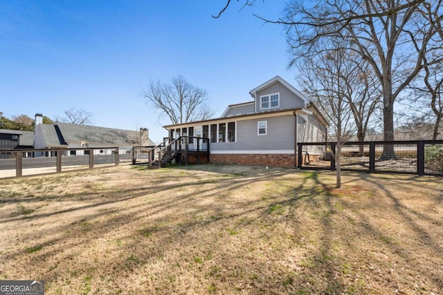 exterior space with stairway, fence, a deck, and a lawn