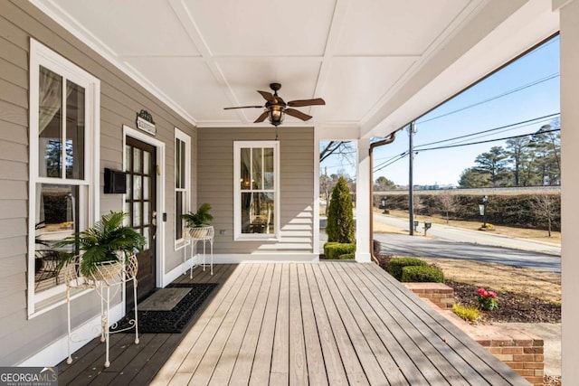 wooden terrace with a ceiling fan