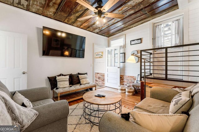 living area with wooden ceiling, ceiling fan, stairs, and wood finished floors