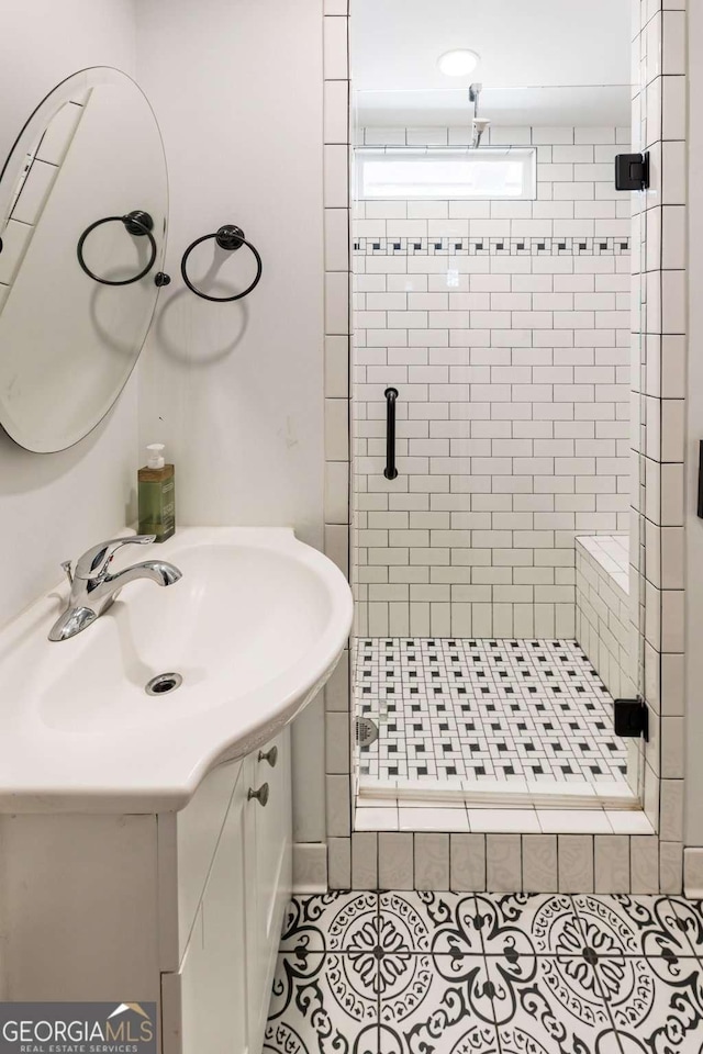 bathroom featuring a stall shower, vanity, and tile patterned floors