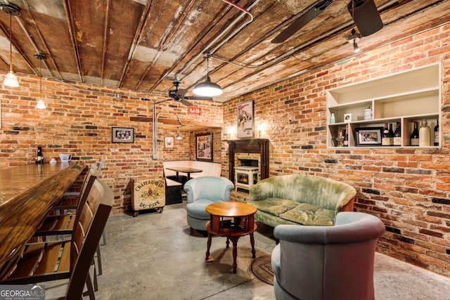 living room with brick wall, concrete floors, and wooden ceiling