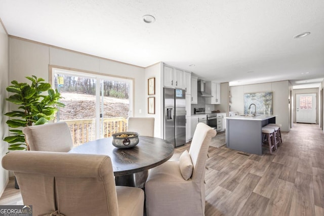 dining area with a healthy amount of sunlight and light wood-type flooring