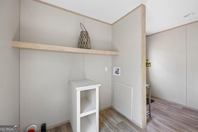 washroom featuring washer hookup, laundry area, and wood finished floors