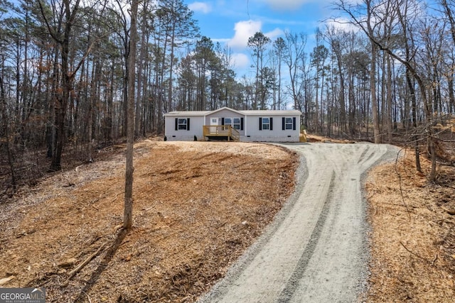 ranch-style house with dirt driveway and crawl space