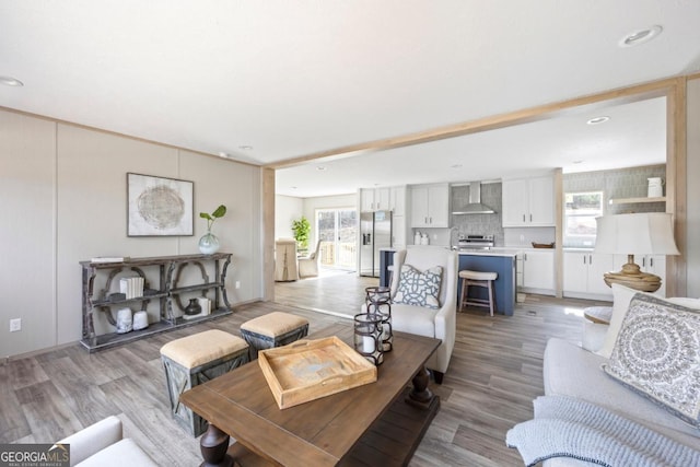 living room with light wood-style flooring, a wealth of natural light, and recessed lighting