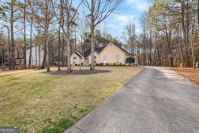 view of front of home featuring a front lawn and stucco siding